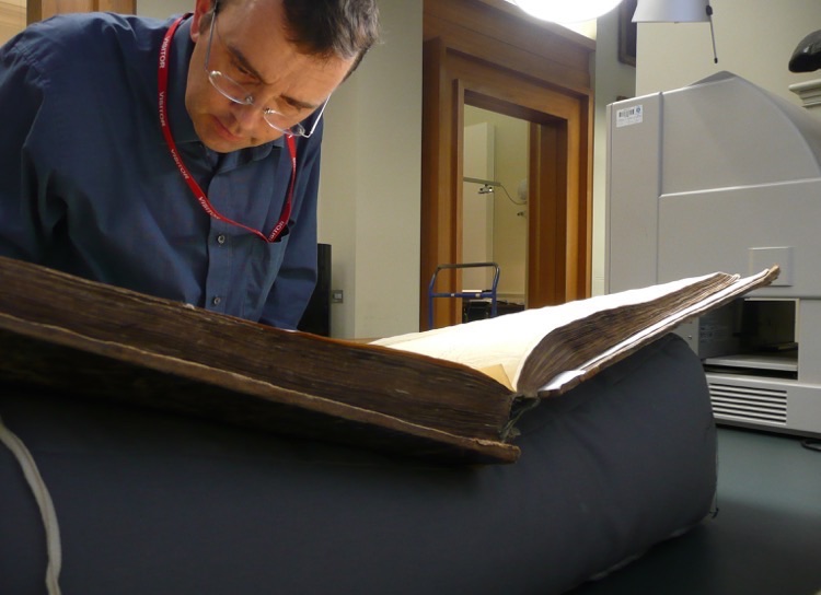 Hamish Macgillivray looking at a reference book